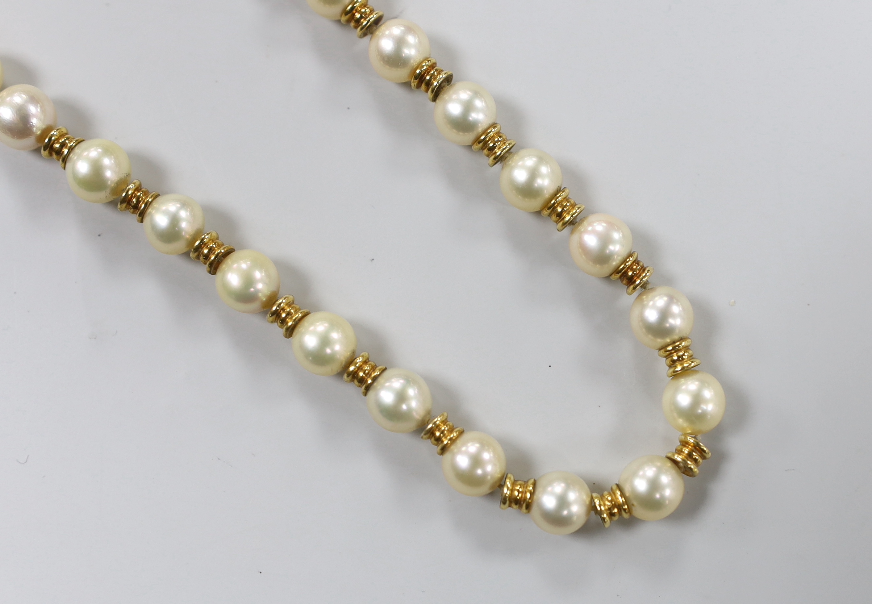 A mid 20th century Italian 750 yellow metal and cultured pearl set single strand necklace, with yellow metal spacers, 38cm, gross weight 38.9 grams.